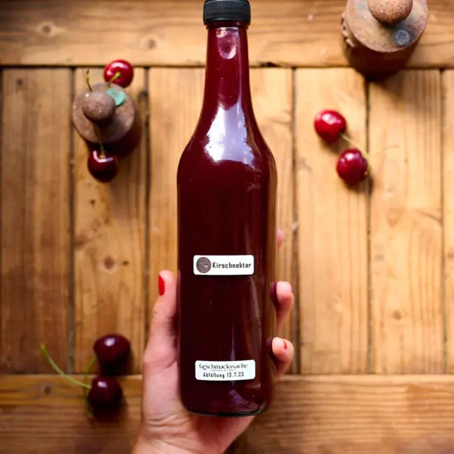 Regionale Fruchtsaftflasche auf rustikalem Holztisch – hausgemachte Getränke im Geschmackssache Laden.